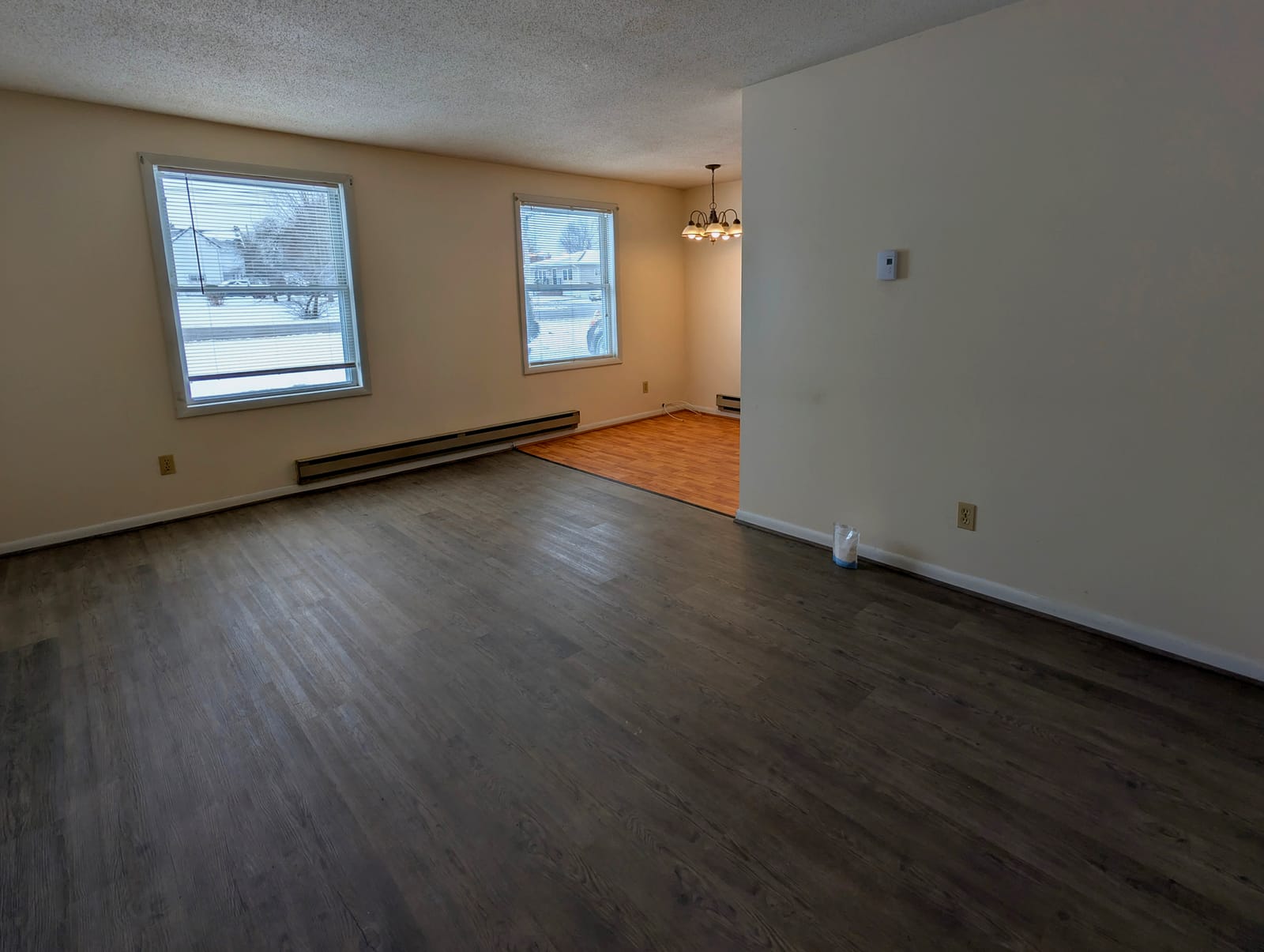 An empty living room, floors clean, ready to hand over.