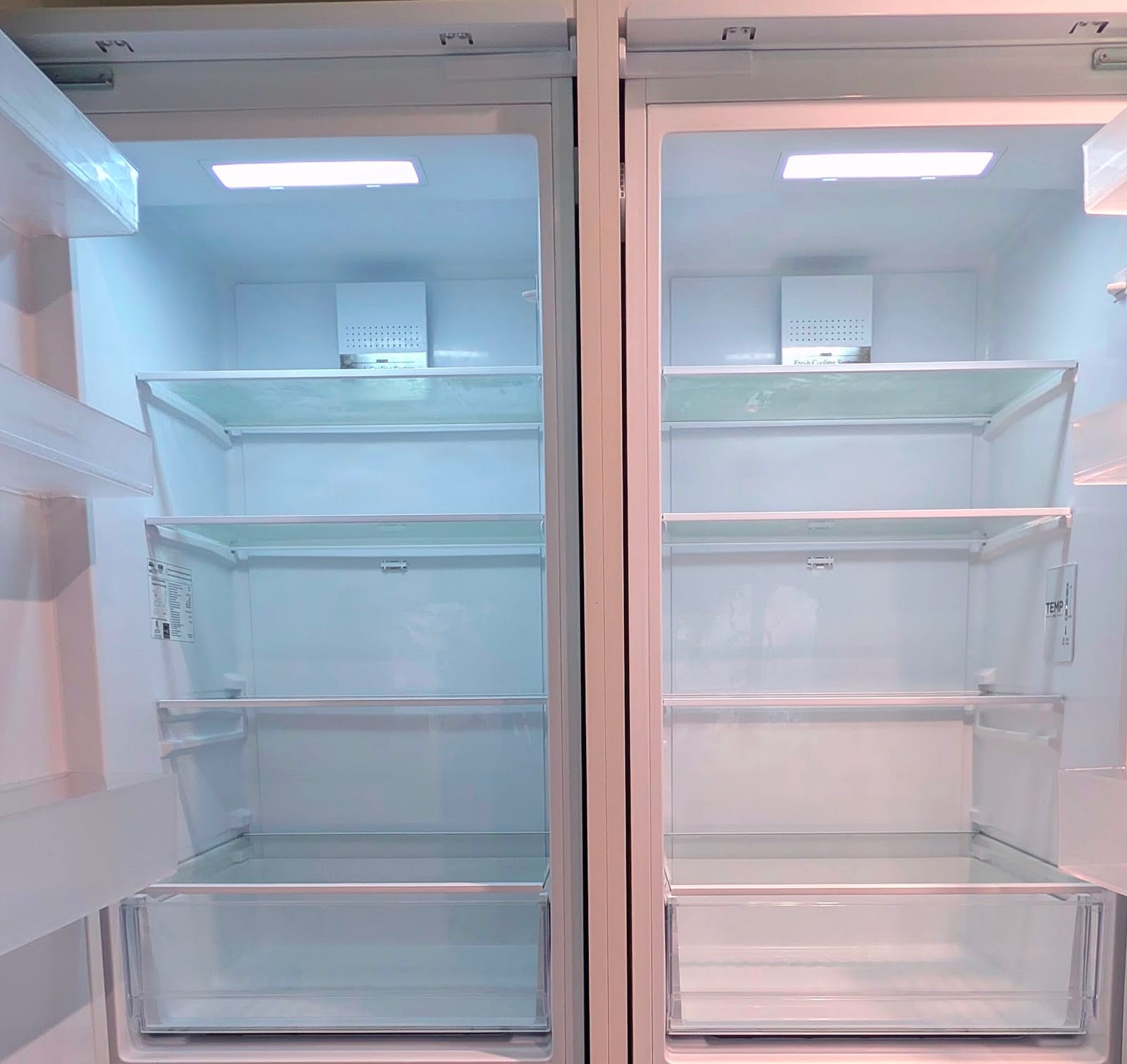 The inside of a refrigerator, emptied and wiped down.